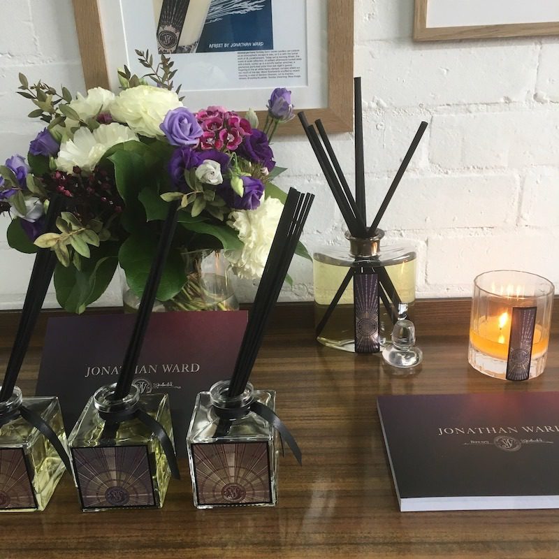 Jonathan Ward diffusers, flowers, lit candle