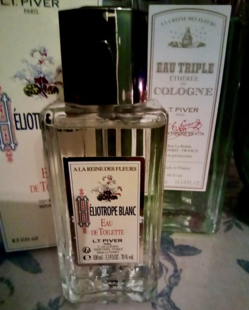 Bottle of L. T. Piver Heliotrope Blanc standing in front of L.T. Piver Eau Triple Etheree, both bottles purchased from mouseyblue-2008 at eBay