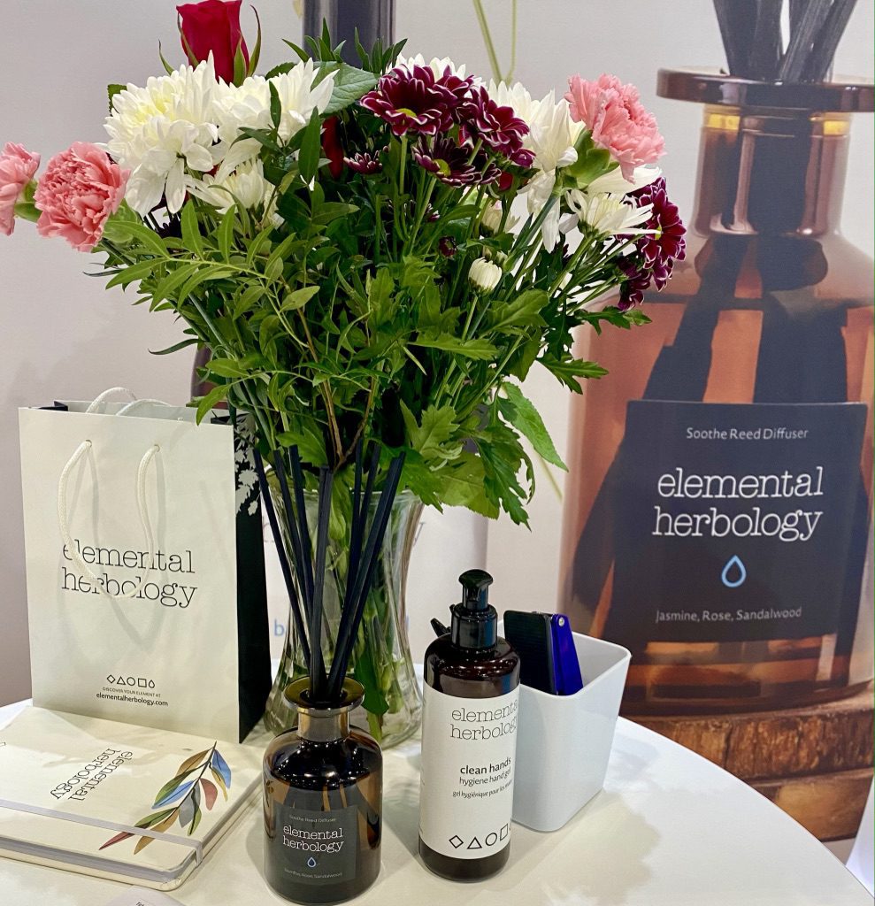 Big bunch of flowers and products on the table of Elemental Herbology at Professional Be23
