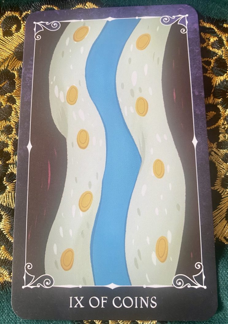 Disney Villains Tarot card shows golden coins on a background of white with a wiggle of blue running through it. Looks like a scarf that an art teacher might wear.