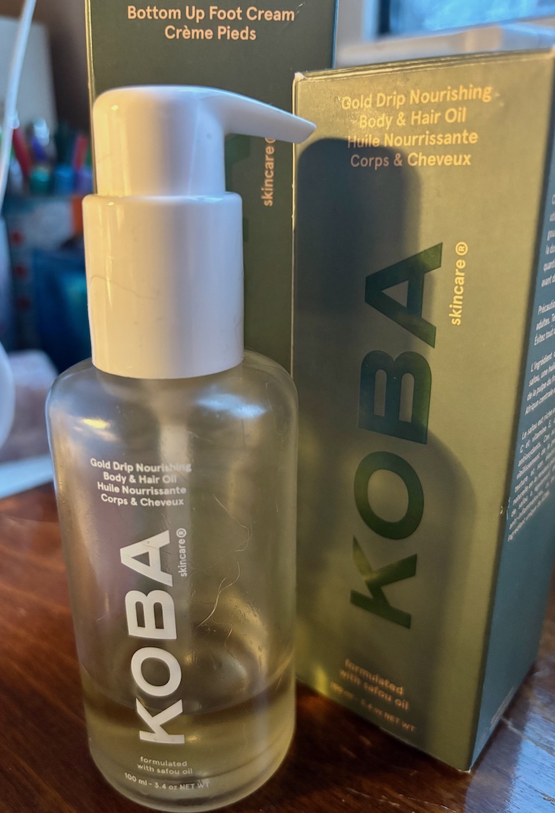 KOBA Gold Drip body oil, almost used up standing against KOBA box