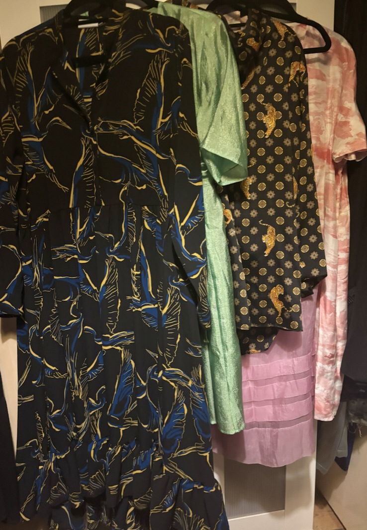 Voluminous garments hanging on a wardrobe door