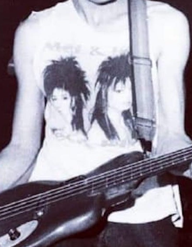 cropped detail of Steve Jameson bass player with World Domination Enterprises wearing his envied by all Mel 'n' Kim t shirt