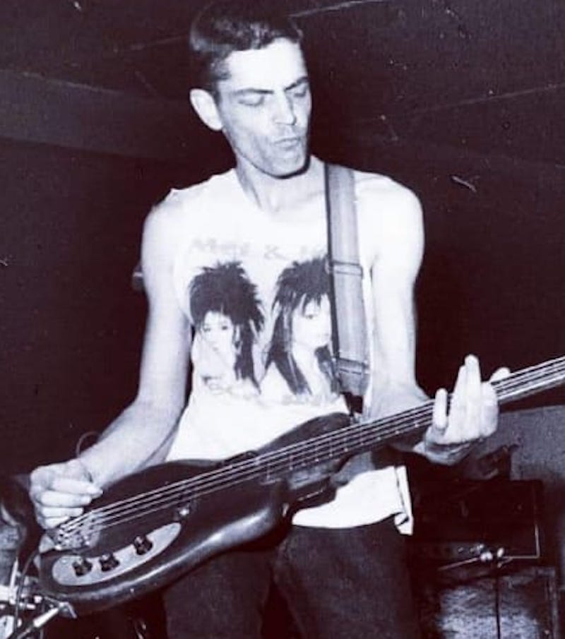 Steve Jameson bass player with World Domination Enterprises wearing his envied by all Mel 'n' Kim t shirt