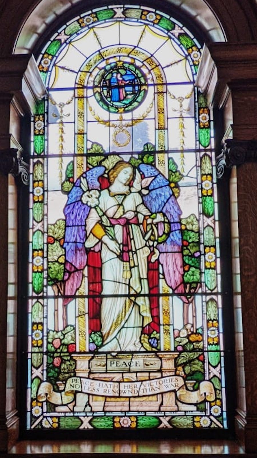 Detail of the center panel of the stained glass 'PEACE' window at Bethnal Green Library